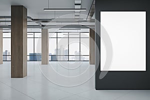 Modern spacious concrete and wooden gallery interior with blank white mock up poster on wall, panoramic windows and city view. 3D