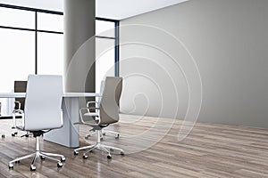 Modern spacious meeting room interior with blank mock up place on wall, white chairs, wooden parquet flooring and panoramic window