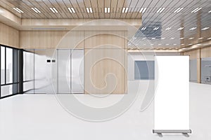 Modern spacious office interior with empty white mock up poster on floor, shiny ceiling, elevators, window and city view,
