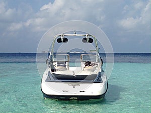 Modern speed boat in the lagoon of tropical island in the Indian Ocean, Maldives