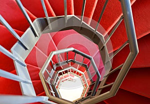 Modern spiral staircase with red carpet