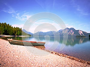 Modern sport fishing paddle boat anchored on shore