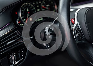 Modern sports car Interior, travel concept. Car dashboard. Focus on headlight knob in the car