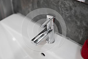 Modern stainless steel faucet with wash basin sink. Counter bathroom interior contemporary. Luxury and stylish design