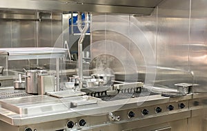 Modern stainless steel hobs in commercial kitchen