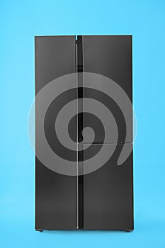 Modern stainless steel refrigerator on background