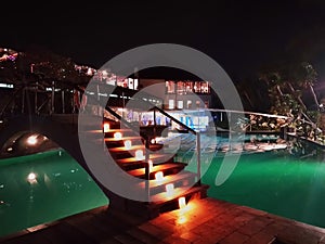 Modern stairway light above swimming pool