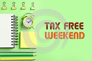 Stationery and text TAX FREE WEEKEND on green background, flat lay