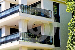 modern steel picket and glass terrace balustrade closeup. stucco and granite exterior wall elevation.