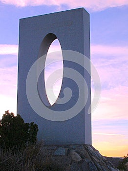 Modern stone sculpture at sunset photo