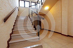Modern stone stairs with wooden banister photo