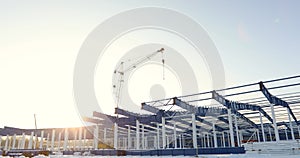 Modern storehouse construction site, the structural steel structure of a new commercial building against a clear blue