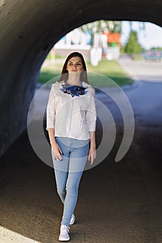 Stylish beautiful girl defiles in a white jacket photo