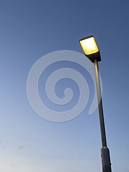 Street lamp glowing on dusk