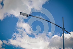 Modern street led lighting pole on blue sky background. Urban electric power technologies. Saving on street city road lighting