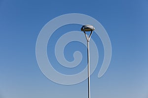 Modern street light against a blue sky background