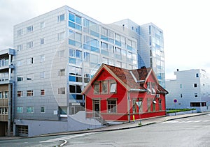 Modern street with an old house