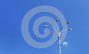 Modern streetlamp against blue sky