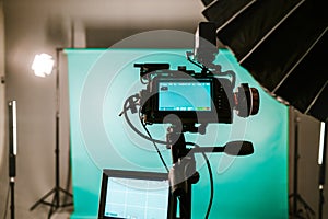 Modern studio with professional video camera and green screen - chromakey. TV camera for recording live show