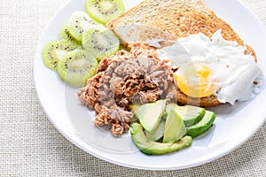 Modern style clean food, bread, egg, tuna salad, kiwi and avocado