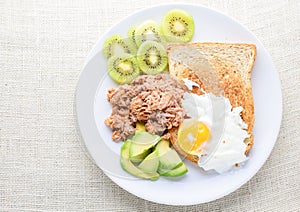 Modern style clean food, bread, egg, tuna salad, kiwi and avocado