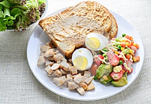 Modern style clean food, Peanut butter with bread, boiled egg, grilled chicken and avocado, strawberry, vegetable salad