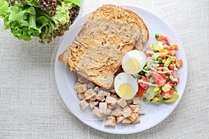 Modern style clean food, Peanut butter with bread, boiled egg, grilled chicken and avocado, strawberry, vegetable salad