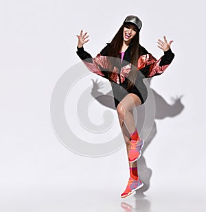 Modern style dancer jumping on studio background
