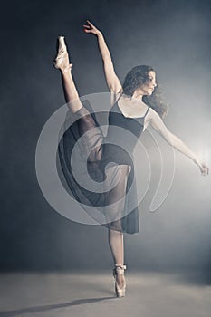 Modern style dancer posing on grey background