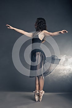 Modern style dancer posing on grey background