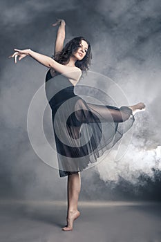 Modern style dancer posing on grey background