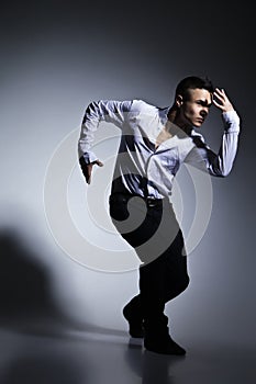 Modern style dancer posing on grey background