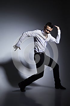 Modern style dancer posing on grey background