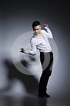 Modern style dancer posing on grey background