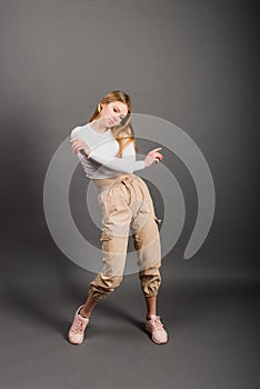 Modern style dancer posing on studio background