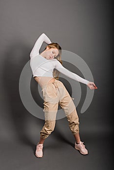 Modern style dancer posing on studio background