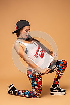 Modern style dancer posing on studio background. Hip hop, jazz funk, dancehall photo