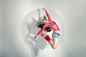 Modern style dancer posing on white background