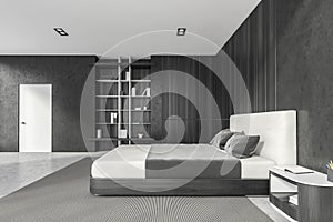 Modern stylish bedroom interior with grey walls, concrete floor, master bed and book shelf niche in the corner. White door
