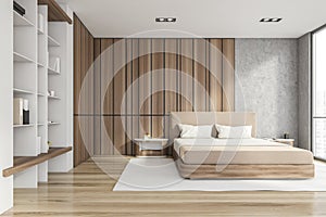 Modern stylish bedroom interior with wooden walls, parquet floor, master bed and book shelf niche in the corner. Sleep concept