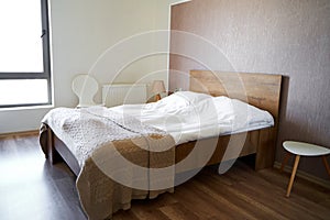 Modern stylish and cozy interior of a bedroom with a double bed in the apartment