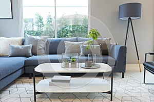 Modern and stylish living room, blue sofa and grey pillow with coffee table