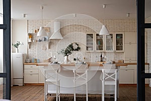 Modern stylish white and light wood Scandinavian kitchen interior with kitchen accessories.