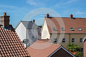 Modern suburban crowded housing estate buildings. Urban house roof tops