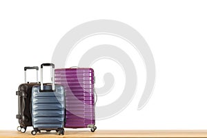 Modern suitcases baggage for travelling or business trip on wooden floor against white isolated background