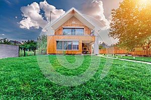 Modern summer cottage against a blue sky in the summer garden