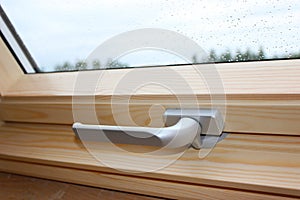 A Modern Sunroof. Handle for opening the attic window, close-up. Mansard Design Of An Attic House. Roofing Construction
