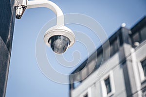 Modern surveillance cameras on the street. Cctv equipment. Blue sky on the background. Protection and control concept.