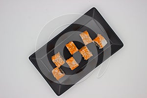 Modern Sushi Presentation on a Black Rectangular Plate