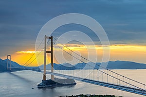 Modern suspension bridge in sunset